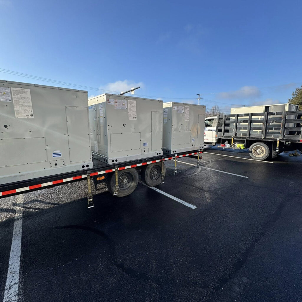 commercial rooftop hvac units on a trailer waiting to be installed by ventec